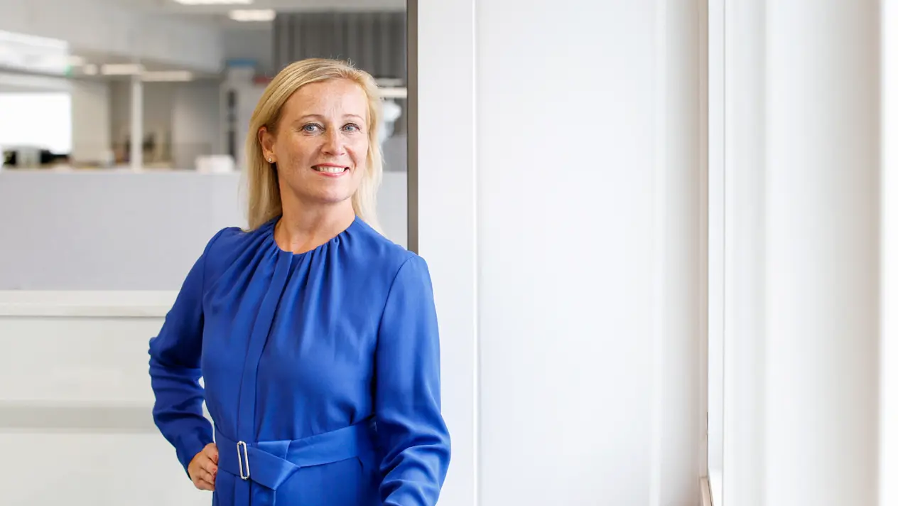 Picture of OAJ president Katarina murto smiling, wearing a blue dress.